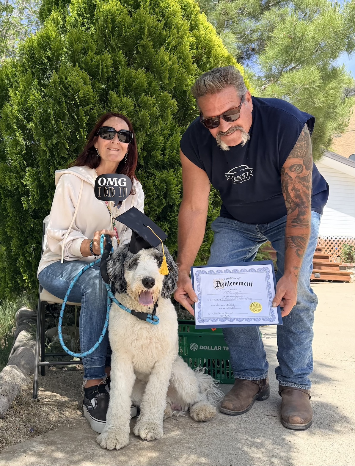 Snake School graduate with family — diploma and a job well done