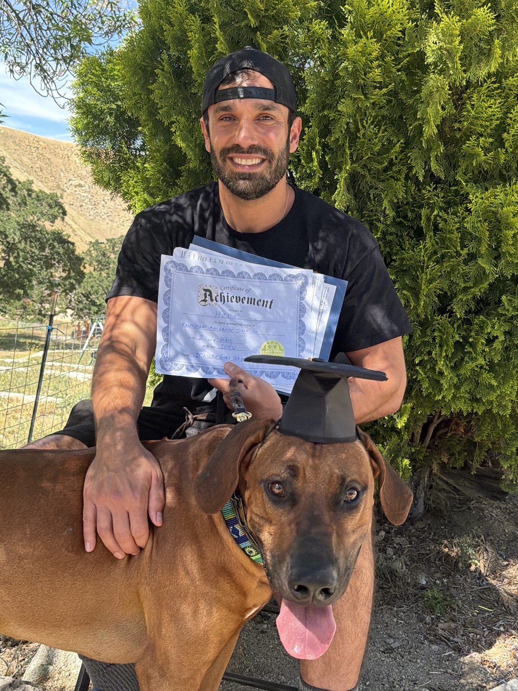 Snake School graduate at the ranch — diploma in hand