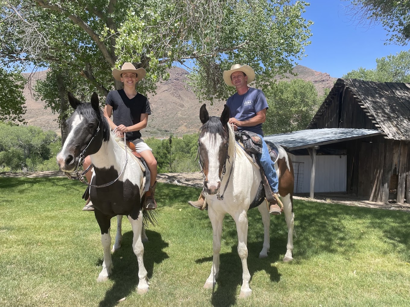 Shane and his son on horseback at the ranch