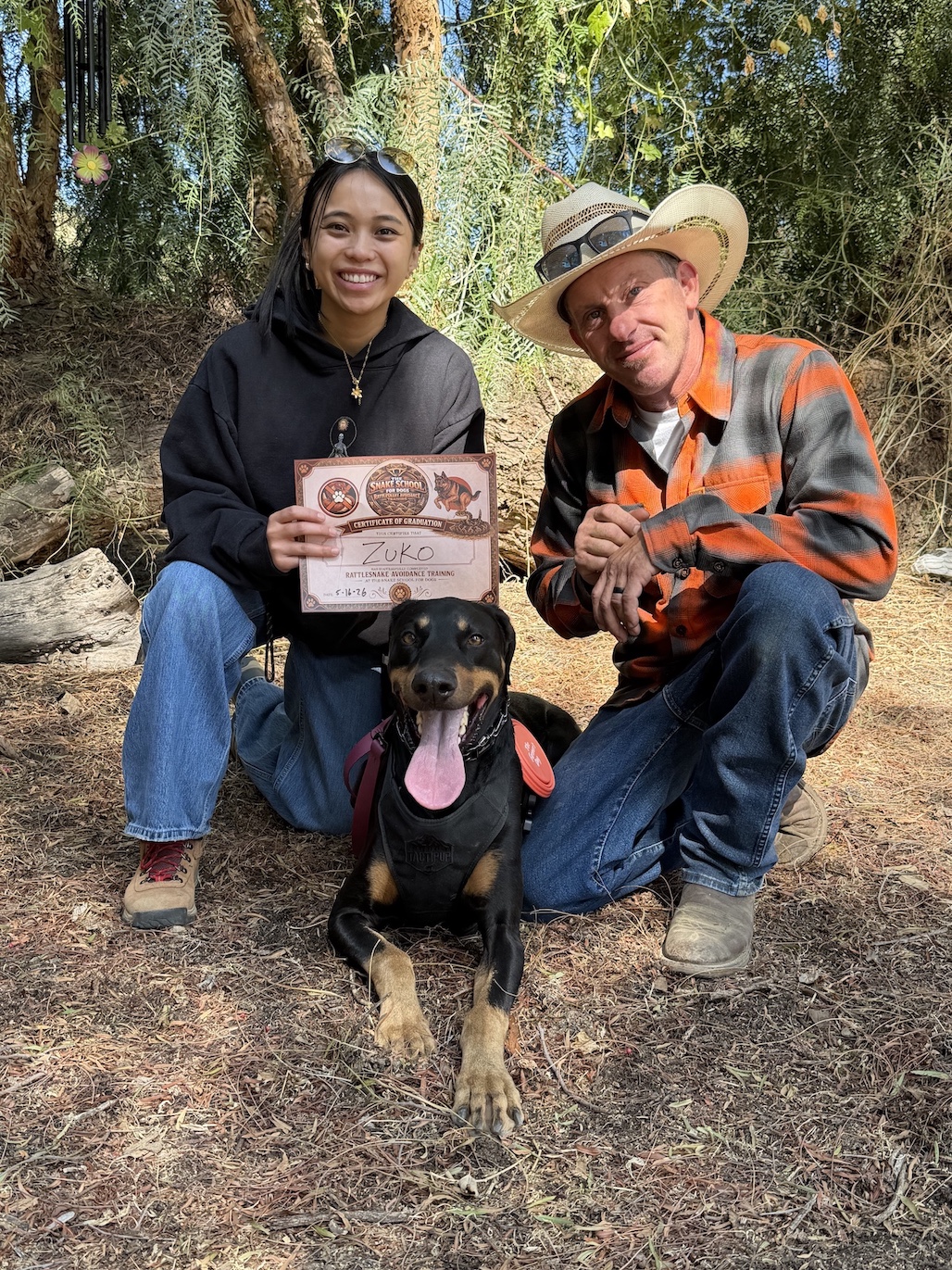 Lead Trainer Shane Armstrong with Snake School graduate Angeline on graduation day