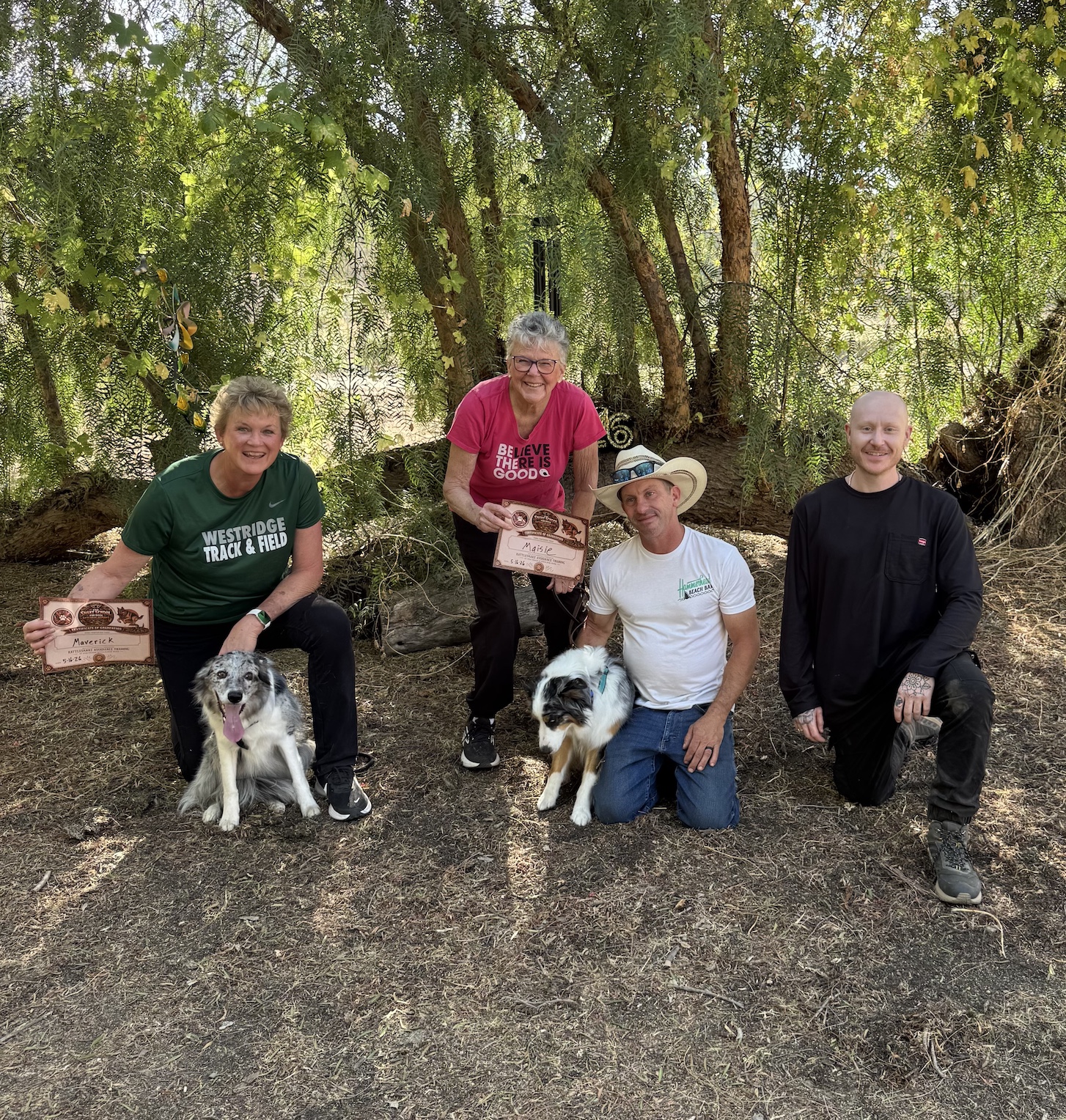 The Snake School graduates with their dogs and diplomas on graduation day