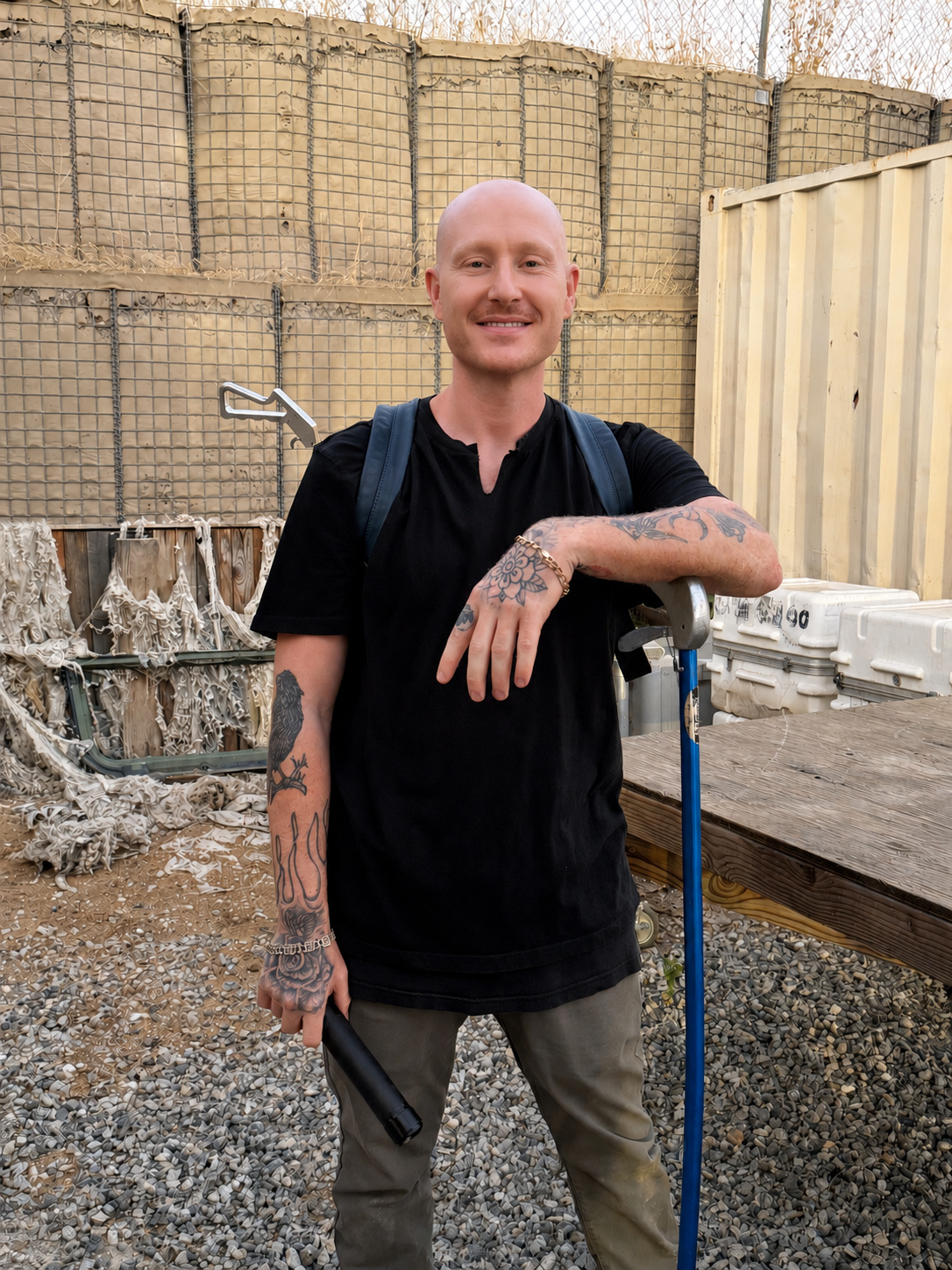 Scott Quashen, a professional snake wrangler, standing by with a catch pole on a film production set